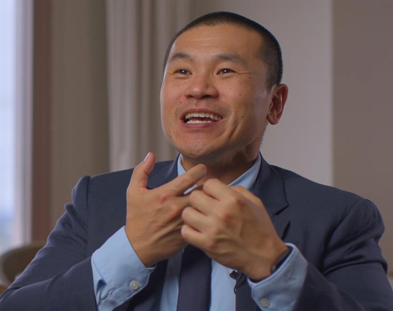 Dr. James Melville smiles and gestures in a still photo from a video interview