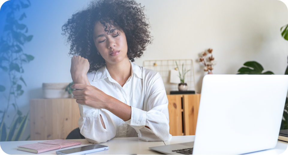 A woman holds her wrist, in pain from nerve damage